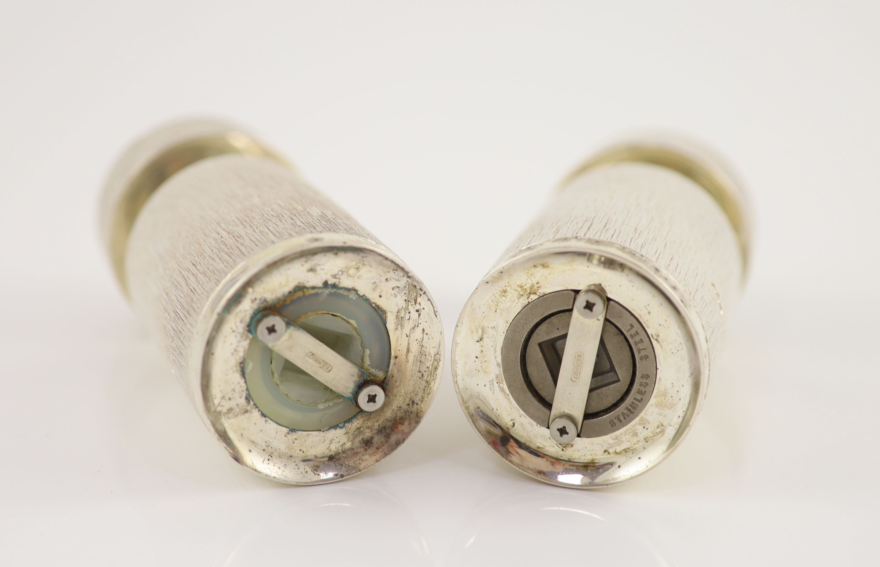 A pair of textured silver salt and pepper mills by Adrian Gerald Benney